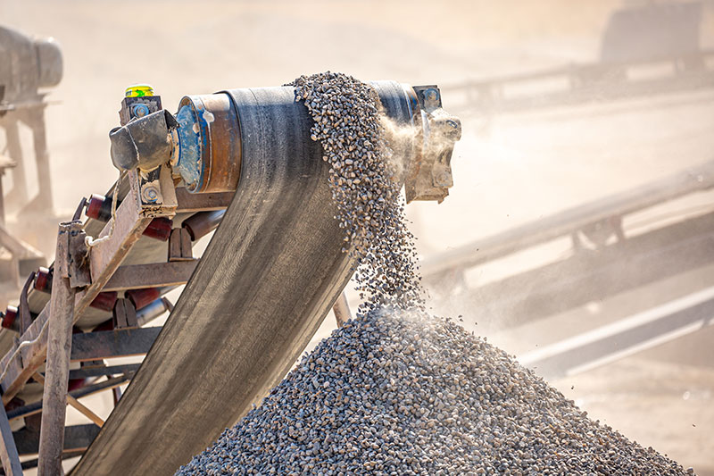 57 Limestone being crushed by machine at quarry mine