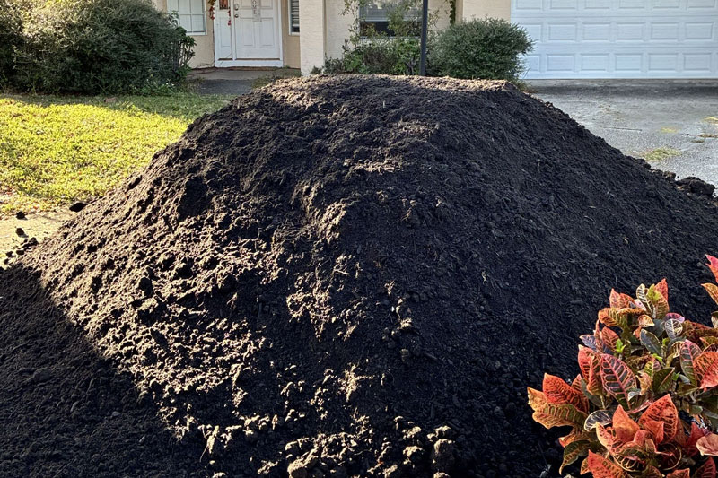 Pile of fresh topsoil in front of Tampa Bay home